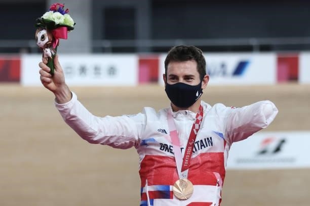 Bronze medalist Jaco van Gass of Team Great Britain celebrates on the podium during the medal ceremony for the Track Cycling Men's C1-2-3 1000m Time...