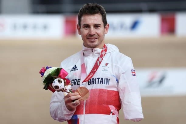 Bronze medalist Jaco van Gass of Team Great Britain celebrates on the podium during the medal ceremony for the Track Cycling Men's C1-2-3 1000m Time...