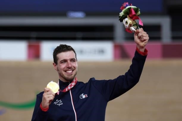 Gold medalist Dorian Foulon of Team France celebrates on the podium during the medal ceremony for the Track Cycling Men's C4 4000m Individual Pursuit...