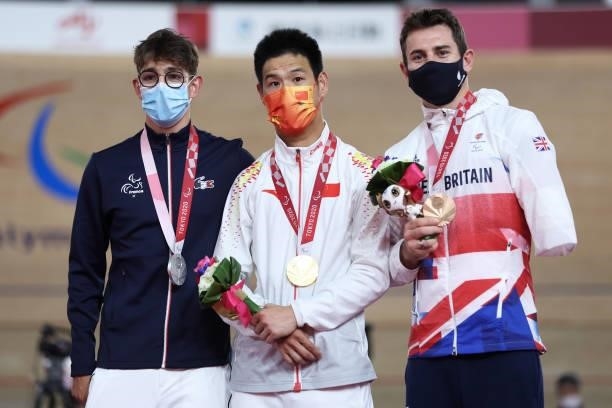 Silver medalist Alexandre Leaute of Team France, gold medalist Li Zhangyu of Team China and bronze medalist Jaco van Gass of Team Great Britain...