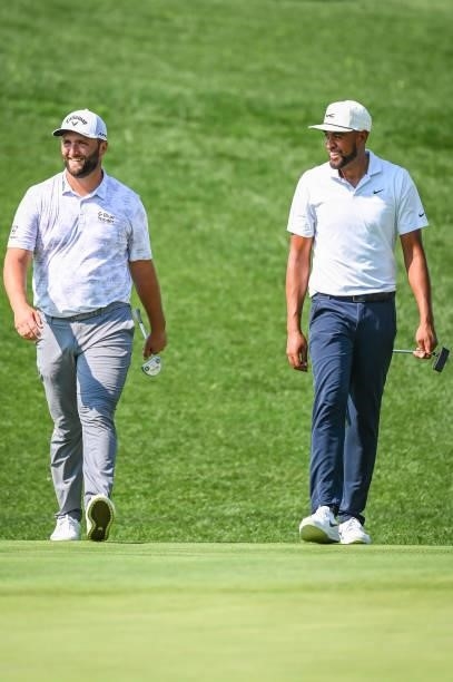 Jon Rahm of Spain and Tony Finau smile on the 17th hole during the first round of the BMW Championship, the second event of the FedExCup Playoffs, at...