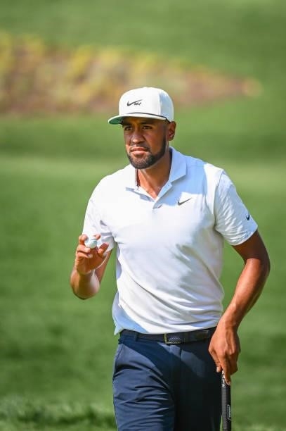 Tony Finau waves his ball to fans to fans after making a birdie putt on the 17th hole green during the first round of the BMW Championship, the...