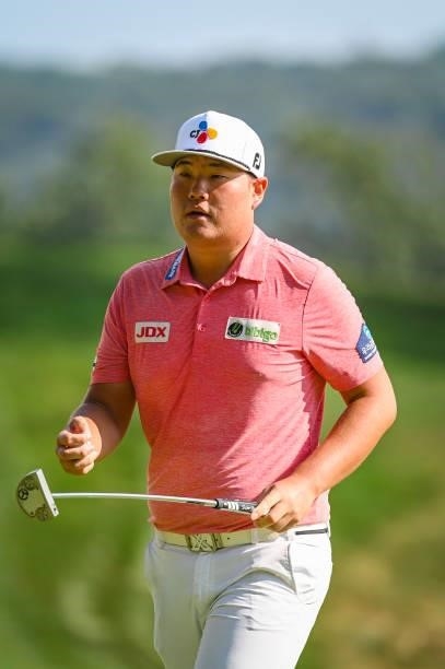 Sungjae Im of South Korea walks off the ninth hole green after making a birdie putt during the first round of the BMW Championship, the second event...