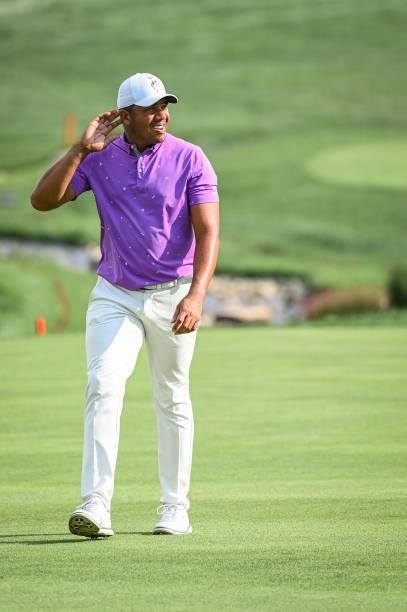 Jhonattan Vegas of Venezuela puts his hand to his ear as he walks up the 18th hole during the first round of the BMW Championship, the second event...