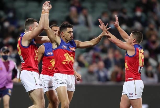 Charlie Cameron of the Lions celebrates a goal with teammates during the 2021 AFL First Qualifying Final match between the Melbourne Demons and the...