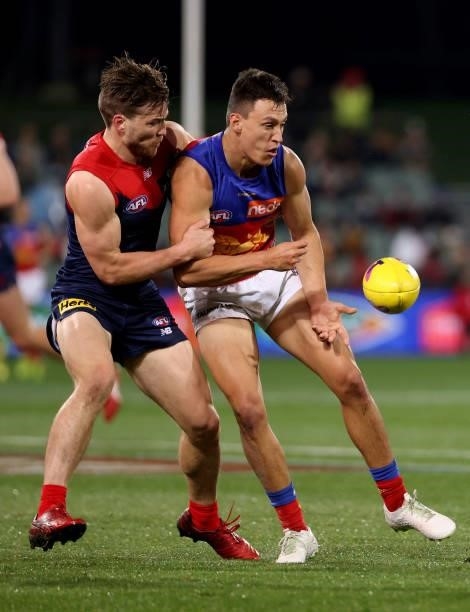 Jack Viney of the Demons tackles Hugh McCluggage of the Lions during the 2021 AFL First Qualifying Final match between the Melbourne Demons and the...