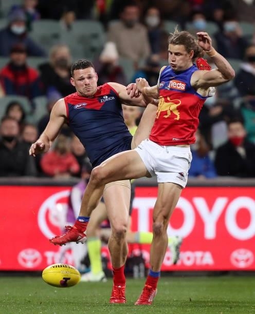 Steven May of the Demons and Jarrod Berry of the Lions during the 2021 AFL First Qualifying Final match between the Melbourne Demons and the Brisbane...