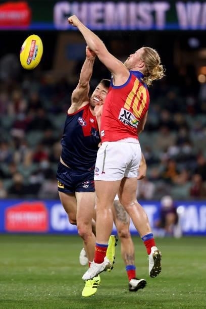 Alex Neal-Bullen of the Demons competes with Daniel Rich of the Lions during the 2021 AFL First Qualifying Final match between the Melbourne Demons...