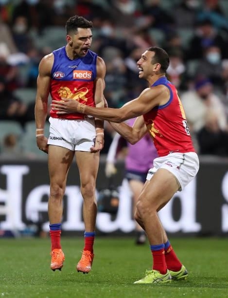 Charlie Cameron of the Lions celebrates a goal with Nakia Cockatoo during the 2021 AFL First Qualifying Final match between the Melbourne Demons and...