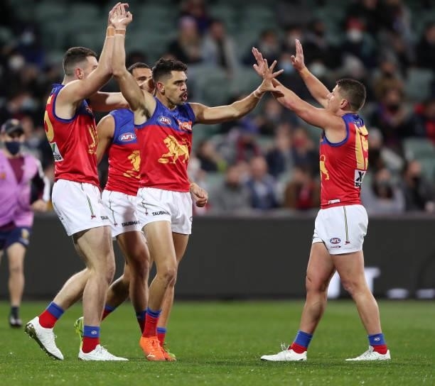 Charlie Cameron of the Lions celebrates a goal with teammates during the 2021 AFL First Qualifying Final match between the Melbourne Demons and the...