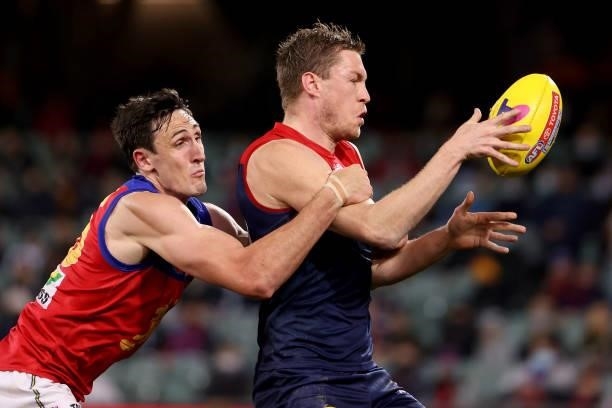 Oscar McInerney of the Lions tackles Tom McDonald of the Demons during the 2021 AFL First Qualifying Final match between the Melbourne Demons and the...