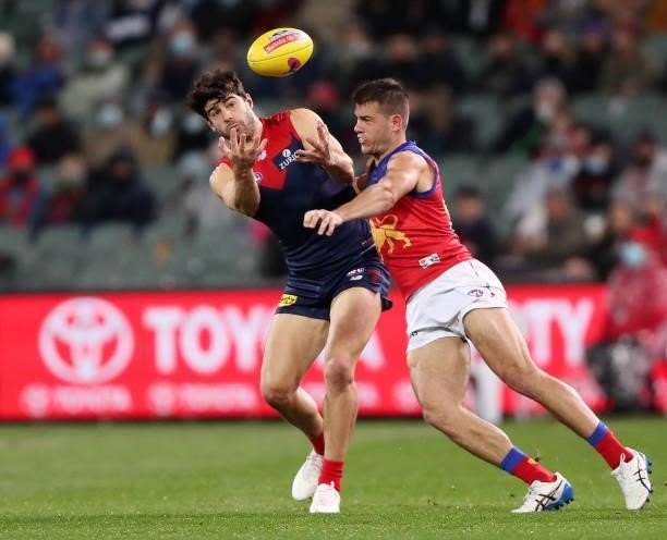 Christian Petracca of the Demons and Brandon Starcevich of the Lions during the 2021 AFL First Qualifying Final match between the Melbourne Demons...