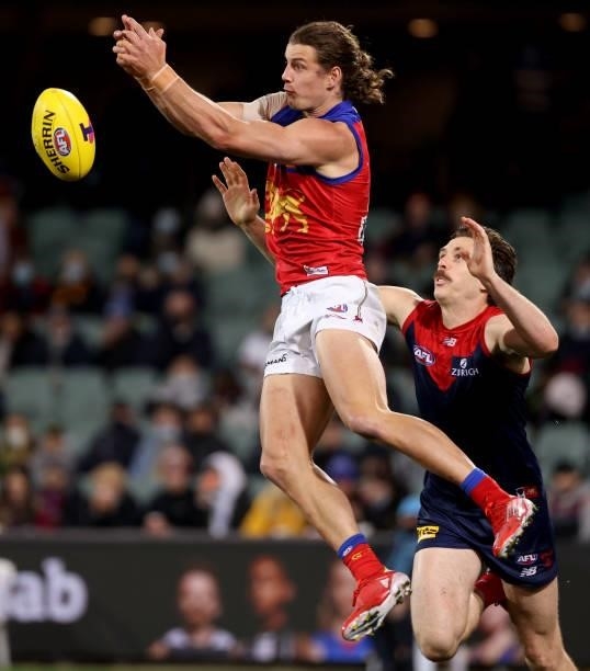 Jarrod Berry of the Lions is tackled by Jake Lever of the Demons during the 2021 AFL First Qualifying Final match between the Melbourne Demons and...