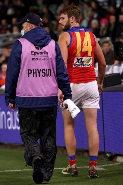 Grant Birchall of the Lions goes off injured during the 2021 AFL First Qualifying Final match between the Melbourne Demons and the Brisbane Lions at...