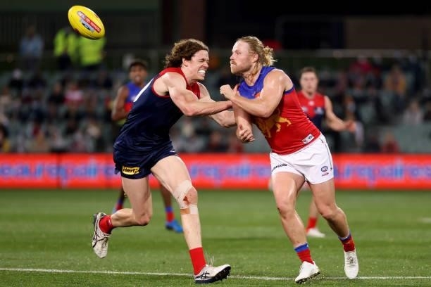 Ben Brown of the Demons tackles Daniel Rich of the Lions during the 2021 AFL First Qualifying Final match between the Melbourne Demons and the...