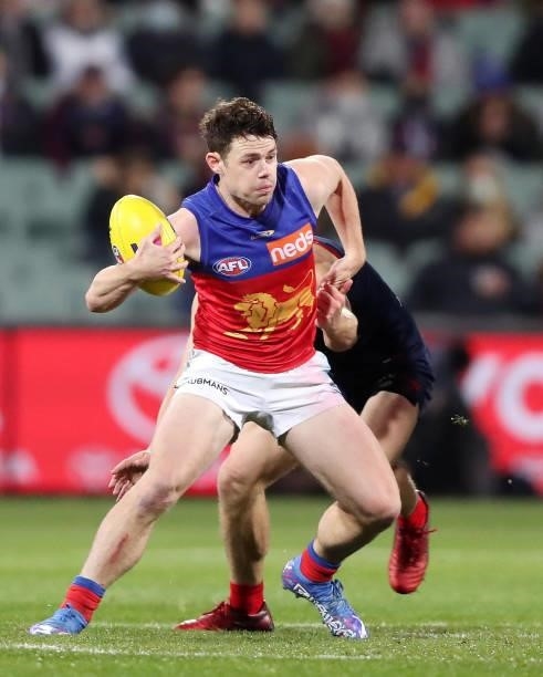 Lachie Neale of the Lions tries to break the tackle of Jack Viney of the Demons during the 2021 AFL First Qualifying Final match between the...