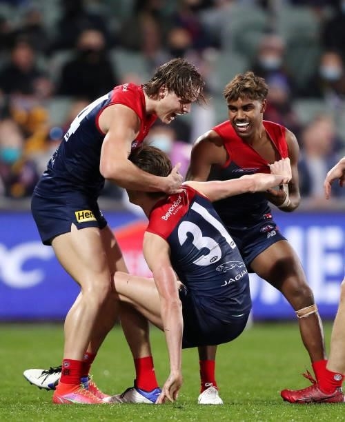 Bayley Fritsch of the Demons celebrates a goal with Kysaiah Pickett and Trent Rivers during the 2021 AFL First Qualifying Final match between the...