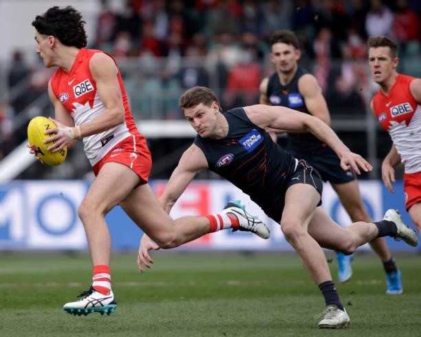 Justin McInerney of the Swans is chased by Jacob Hopper during the 2021 AFL Second Elimination Final match between the Sydney Swans and the GWS...