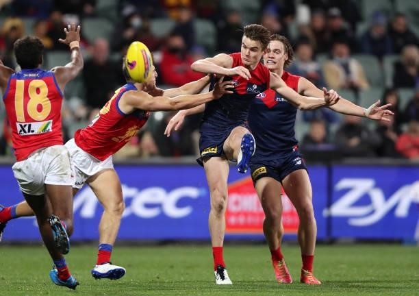 Bayley Fritsch of the Demons snaps a goal with Zac Bailey of the Lions and Trent Rivers of the Demons during the 2021 AFL First Qualifying Final...