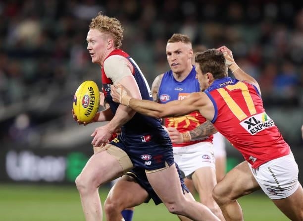 Clayton Oliver of the Demons and Jarryd Lyons of the Lions during the 2021 AFL First Qualifying Final match between the Melbourne Demons and the...