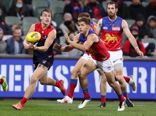 Trent Rivers of the Demons handpasses the ball away from Zac Bailey during the 2021 AFL First Qualifying Final match between the Melbourne Demons and...