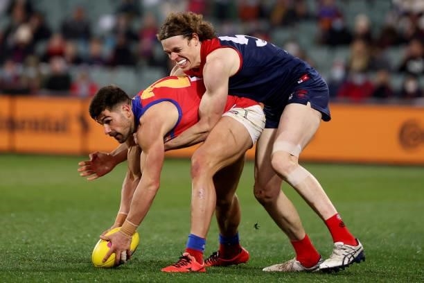 Marcus Adams of the Lions is tackled by Ben Brown of the Demons during the 2021 AFL First Qualifying Final match between the Melbourne Demons and the...