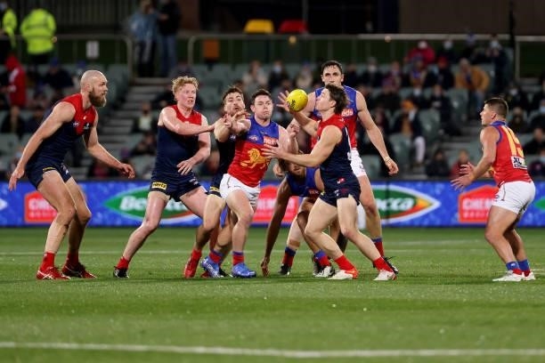 Clayton Oliver of the Demons competes with Lachie Neale of the Lions during the 2021 AFL First Qualifying Final match between the Melbourne Demons...