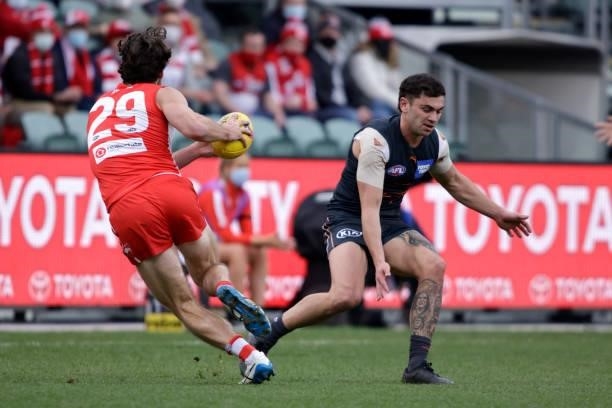 Lewis Taylor of the Swans side steps Tim Taranto of the Giants during the 2021 AFL Second Elimination Final match between the Sydney Swans and the...