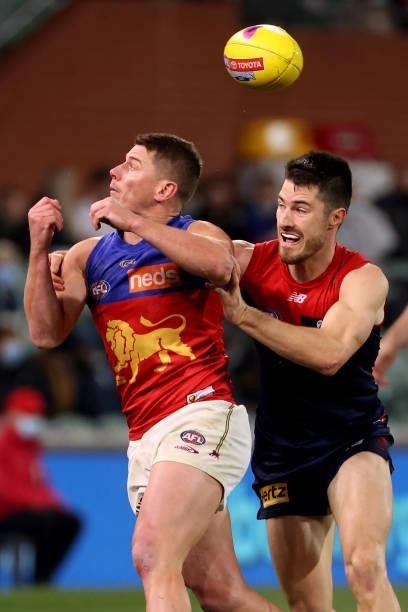Dayne Zorko of the Lions is tackled by Alex Neal-Bullen of the Demons during the 2021 AFL First Qualifying Final match between the Melbourne Demons...