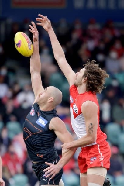 Tom Hickey of the Swans and Shane Mumford of the Giants compete in a ruck contest during the 2021 AFL Second Elimination Final match between the...