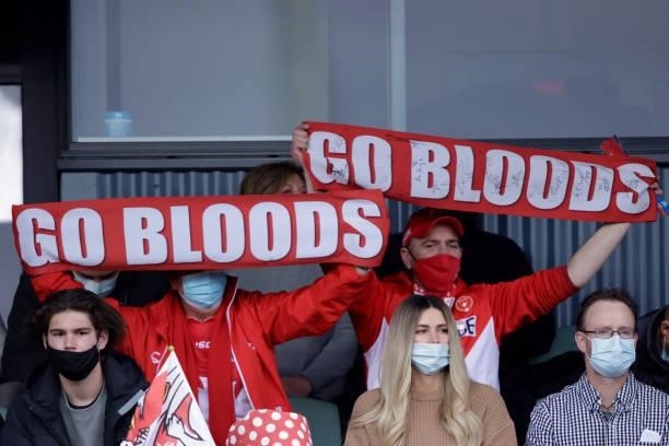 Fans celebrate during the 2021 AFL Second Elimination Final match between the Sydney Swans and the GWS Giants at University of Tasmania Stadium on...