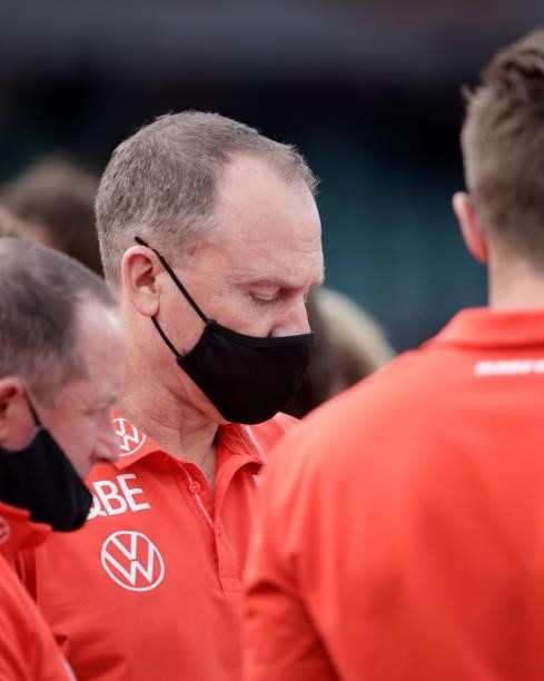 John Longmire, Senior Coach of the Swans talks to his coaches during the 2021 AFL Second Elimination Final match between the Sydney Swans and the GWS...