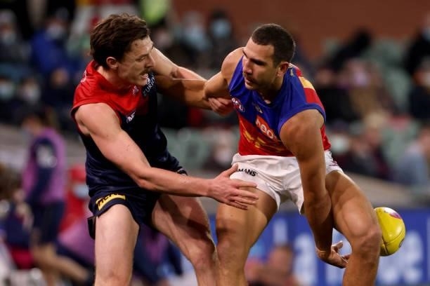 Jake Lever of the Demons is tackled by Nakia Cockatoo of the Lions during the 2021 AFL First Qualifying Final match between the Melbourne Demons and...