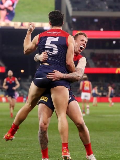 Christian Petracca of the Demons celebrates a goal with James Harmes during the 2021 AFL First Qualifying Final match between the Melbourne Demons...