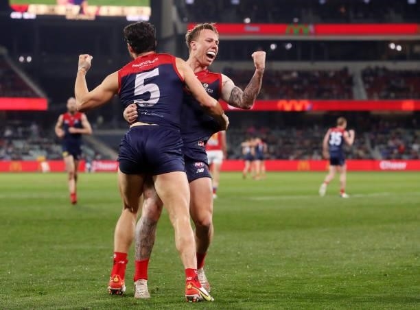 Christian Petracca of the Demons celebrates a goal with James Harmes during the 2021 AFL First Qualifying Final match between the Melbourne Demons...
