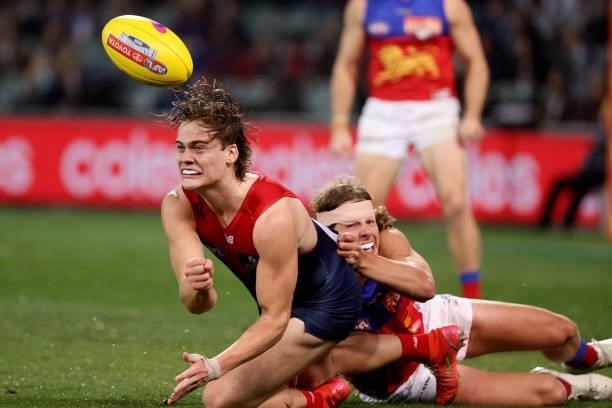 Trent Rivers of the Demons is tackled by Tom Fullarton of the Lions during the 2021 AFL First Qualifying Final match between the Melbourne Demons and...
