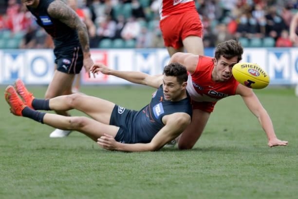 Josh Kelly of the Giants is tackled by Oliver Florent of the Swans during the 2021 AFL Second Elimination Final match between the Sydney Swans and...