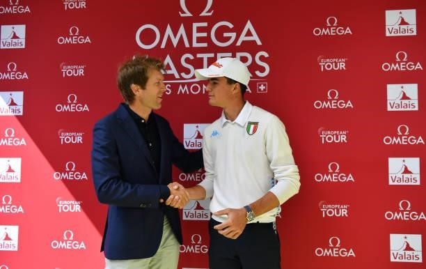 Pietro Bovari of Italy , with Jean Pascal Perret of Omega , after his hole in one during Day Three of The Omega European Masters at Crans-sur-Sierre...