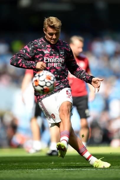 Arsenal's Norwegian midfielder Martin Odegaard warms up ahead of the English Premier League football match between Manchester City and Arsenal at the...
