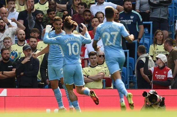 Manchester City's Spanish midfielder Ferran Torres celebrates with team mates after he scores his team's opening goal during the English Premier...