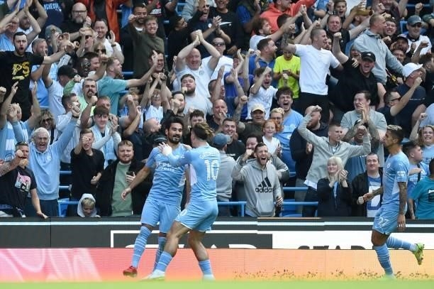 Manchester City's German midfielder Ilkay Gundogan celebrates scoring his team's first goal with Manchester City's English midfielder Jack Grealish...