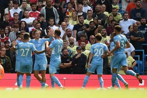 Manchester City's Spanish midfielder Ferran Torres celebrates with team mates after he scores his team's opening goal during the English Premier...