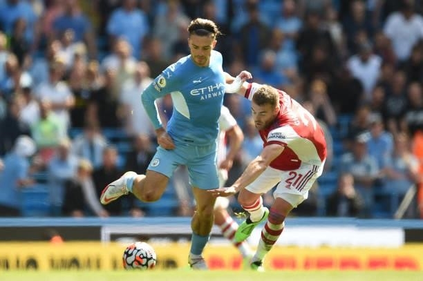 Manchester City's English midfielder Jack Grealish vies with Arsenal's English defender Calum Chambers during the English Premier League football...