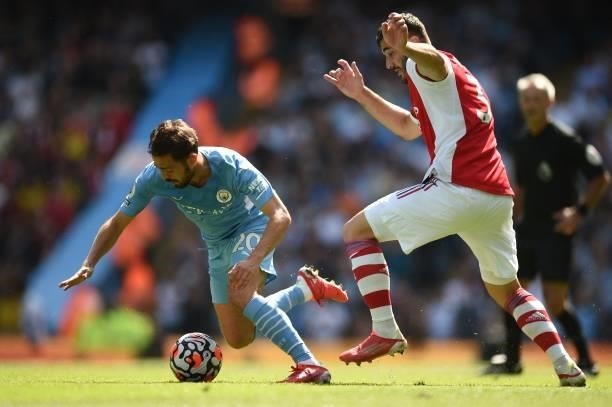 Manchester City's Portuguese midfielder Bernardo Silva vies with Arsenal's German-born Bosnian defender Sead Kolasinac during the English Premier...