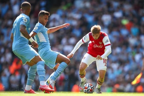 Rodri of Manchester City and Emile Smith Rowe of Arsenal during the Premier League match between Manchester City and Arsenal at Etihad Stadium on...