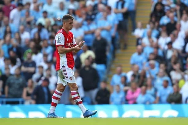 Granit Xhaka of Arsenal walks off after being sent off during the Premier League match between Manchester City and Arsenal at Etihad Stadium on...
