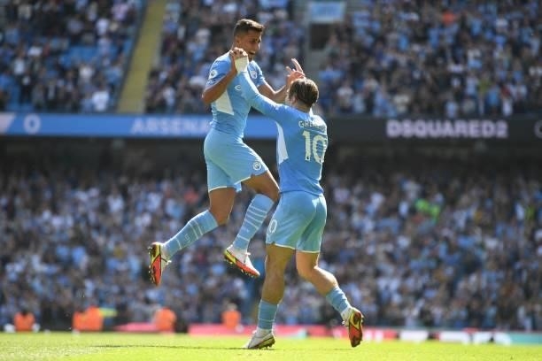 Manchester City's Spanish midfielder Rodrigo celebrates with Manchester City's English midfielder Jack Grealish after scoring his team's fourth goal...