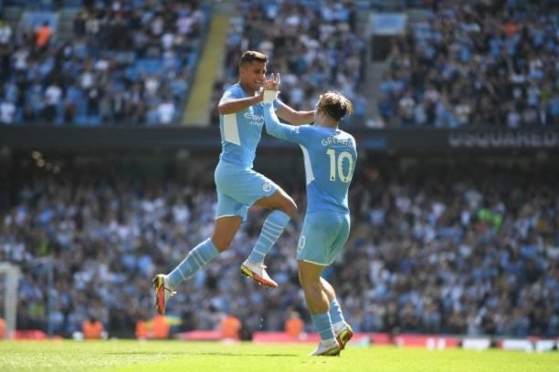 Manchester City's Spanish midfielder Rodrigo celebrates with Manchester City's English midfielder Jack Grealish after scoring his team's fourth goal...