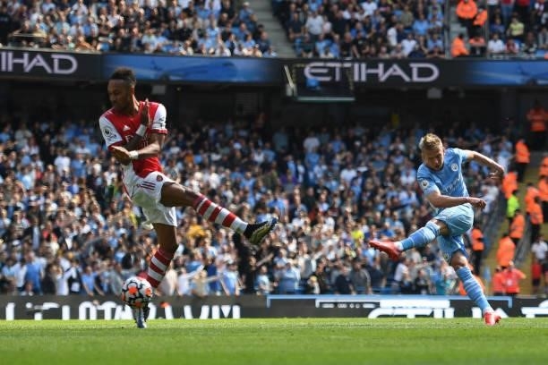 Manchester City's Portuguese defender Joao Cancelo takes a shot past Arsenal's Gabonese striker Pierre-Emerick Aubameyang during the English Premier...