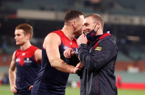 Simon Goodwin, Senior Coach of the Demons with Steven May after the win during the 2021 AFL First Qualifying Final match between the Melbourne Demons...